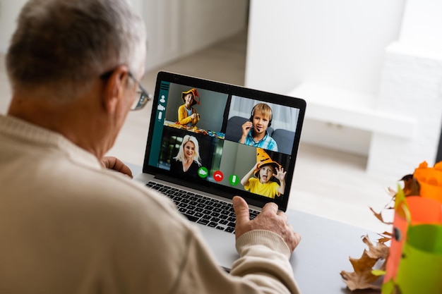 Elderly man with laptop and video from grandchildren