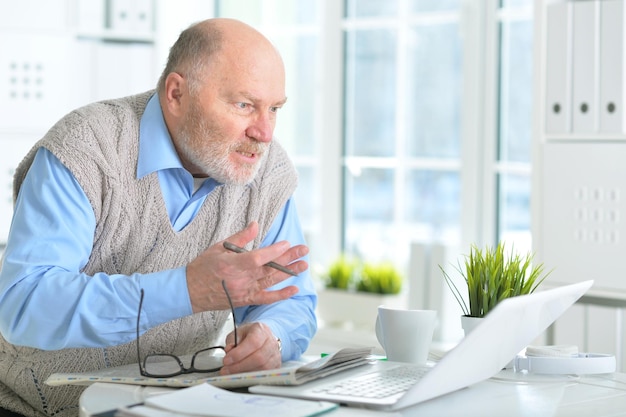 Elderly man with a laptop