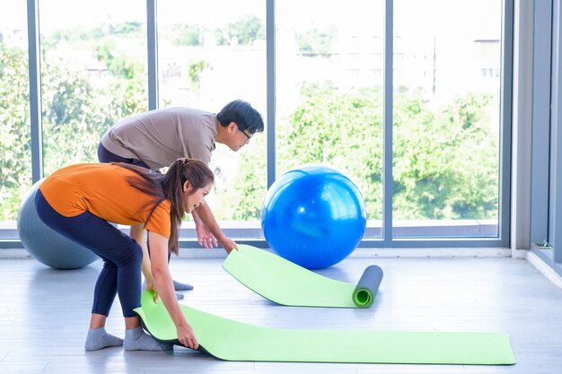 Elderly men and women are laying yoga mats