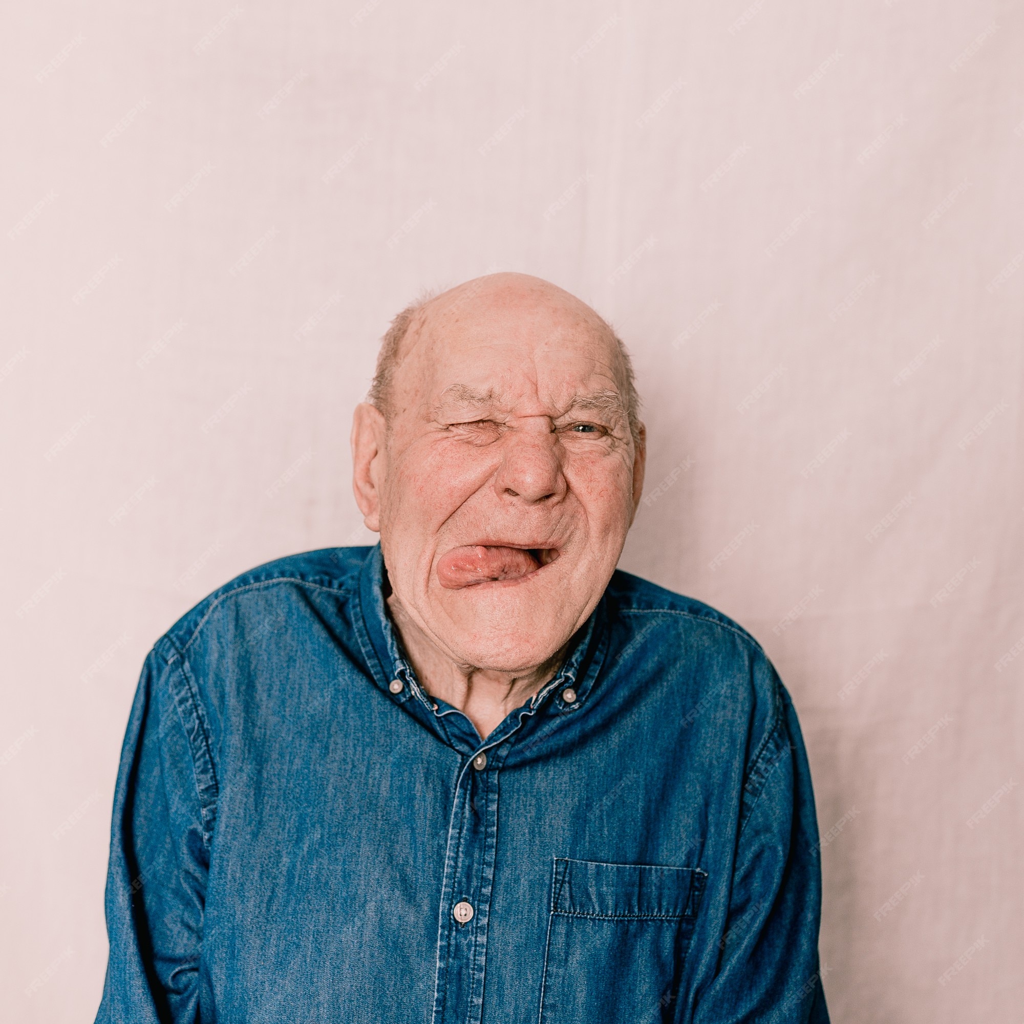Premium Photo | An elderly old man grimaces, makes a face and shows his  tongue. crazy funny man