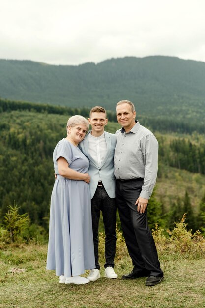 Elderly parents with a young wedding couple after a wedding ceremony in the mountains