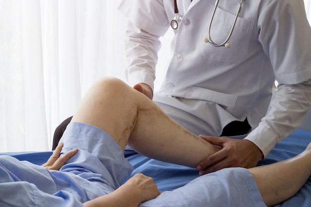 Elderly patient care concept; Asian doctor is taking care elderly patient woman in hospital.