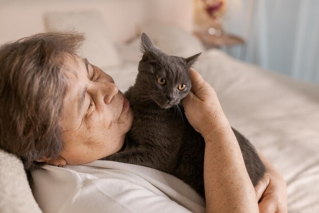 Elderly people take care of cats and enjoy them at home