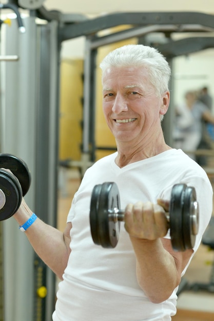 Elderly in sportswear practice sports in the gym