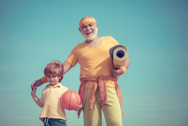 Elderly sporty man and young boy sporting morning workout copy space Healthy family lifestyle Sport yoga and fitness Rehabilitation