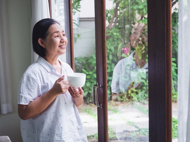 The elderly thinking something with drink coffee