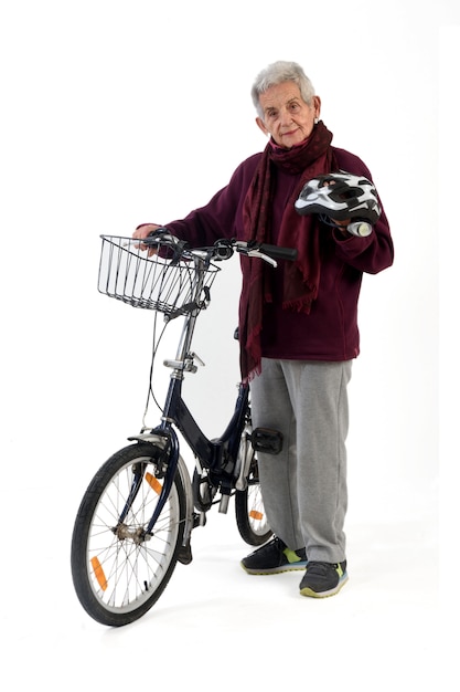 Elderly woman on a bicycle on a white background