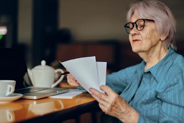 Elderly woman in a cafe a cup of drink laptop Social networks unaltered