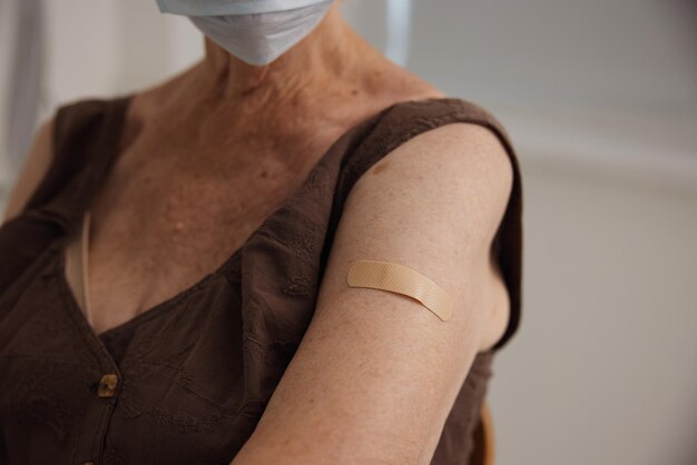 Elderly woman in clinic vaccine passport protection immunity closeup