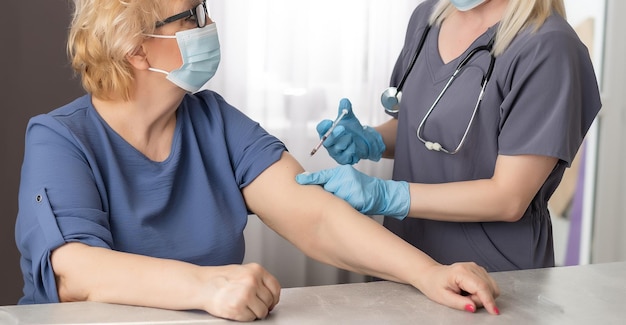 Elderly woman at doctor during coronavirus pandemic.