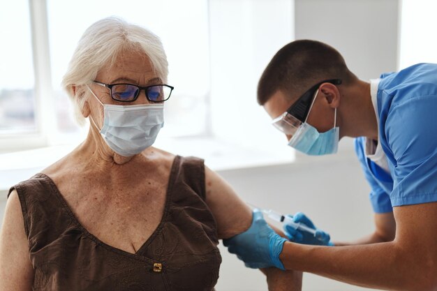 Photo elderly woman at the doctor39s appointment vaccination covid passport