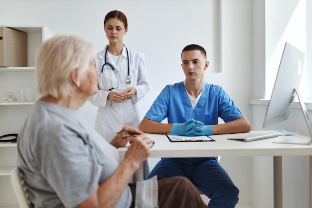 An elderly woman at a doctor39s appointment with a nurse in a hospital