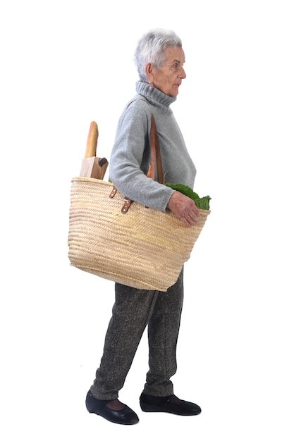 Elderly woman going shopping isolated on white,