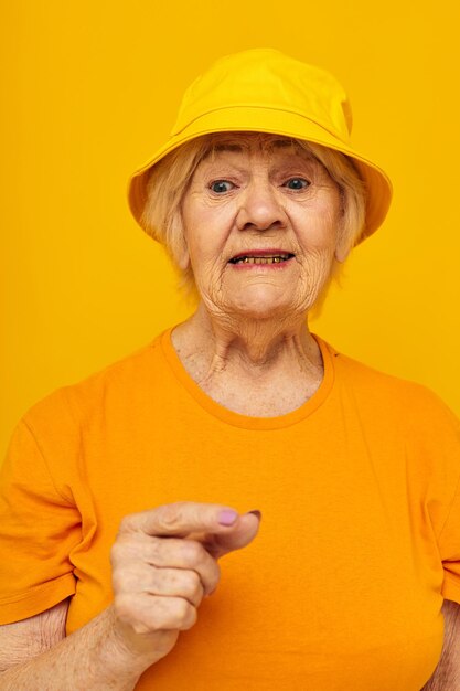 Elderly woman happy lifestyle in a yellow headdress yellow background