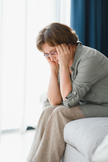 An elderly woman has headaches she touches her head with her\
hands reports symptoms of dizziness migraines