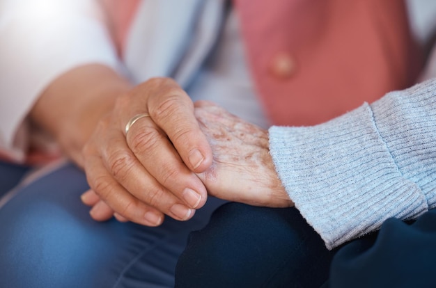 Elderly woman holding hands and close up of support care and trust relationship bonding together Love friends relax and gratitude for senior friendship kindness and solidarity in nursing home