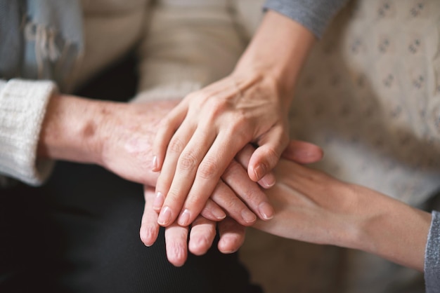 Elderly woman holding hands with daughter