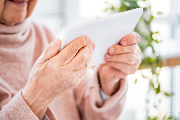 Elderly woman holding tablet