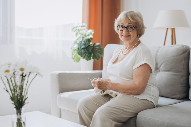 elderly woman knitting at home creative hobby