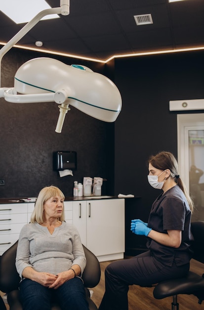 Elderly woman during the medical examination with male dentist in the dental office