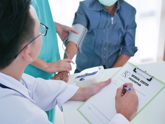 Elderly woman meeting doctor in hospital.