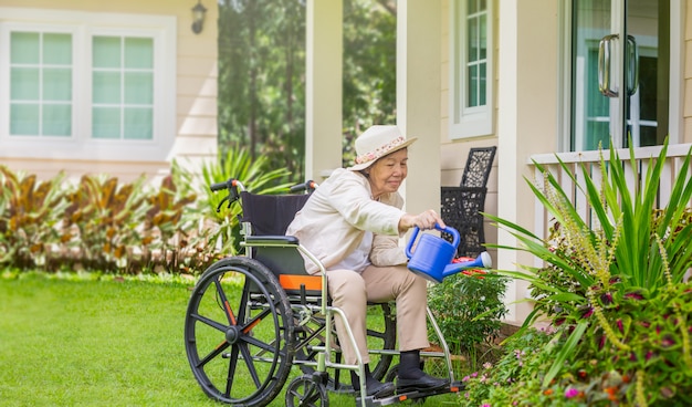 Elderly woman relaxes with gardening in backyard