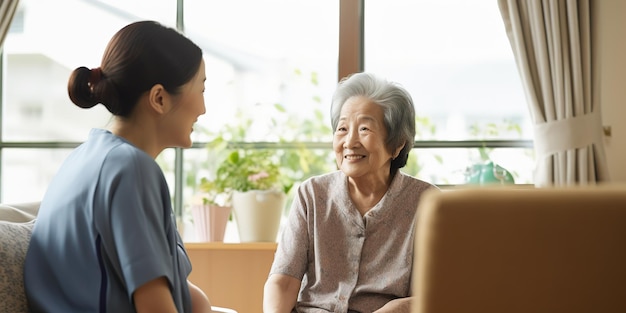 Elderly woman sitting in a chair and talking to a nurse in a nursing home