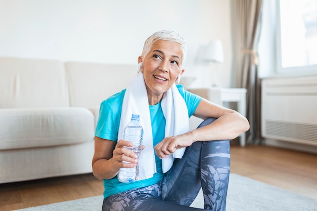 Elderly woman sitting on the mat