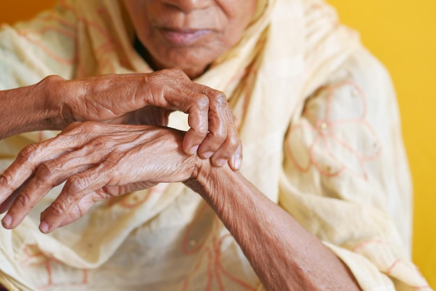 Elderly woman suffering pain on hand