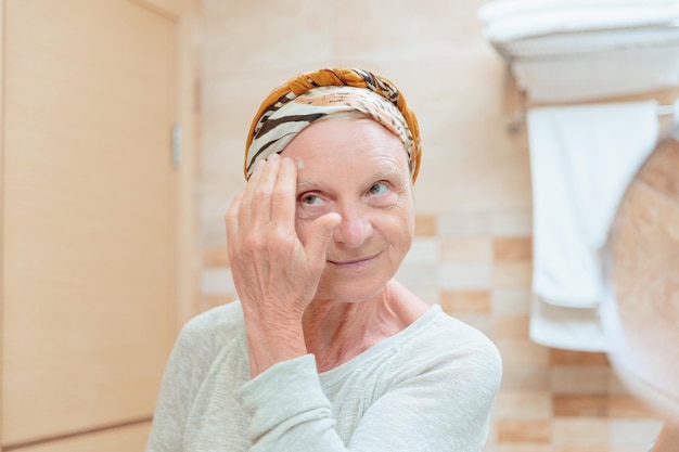 Elderly woman taking care of her face