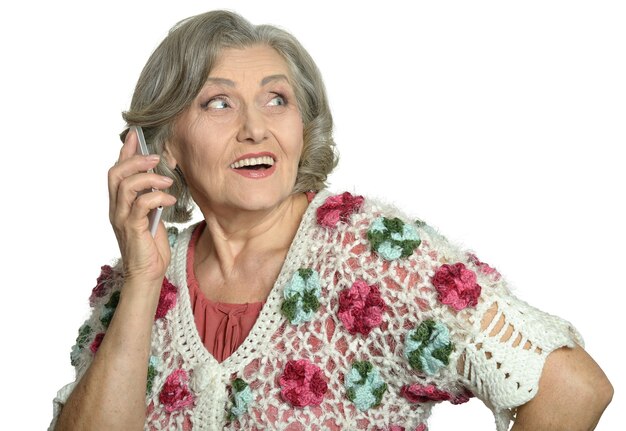 Elderly woman talking on mobile phone on a white background