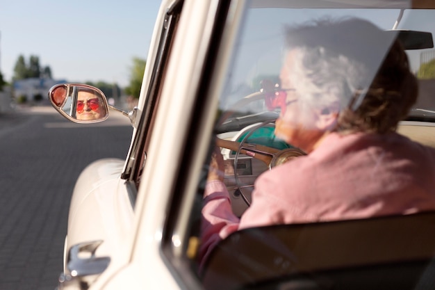 Elderly woman traveling by her car