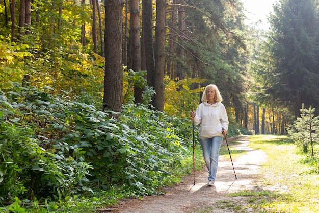 Elderly woman trekking outdoors