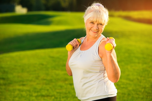 Elderly woman with dumbbells