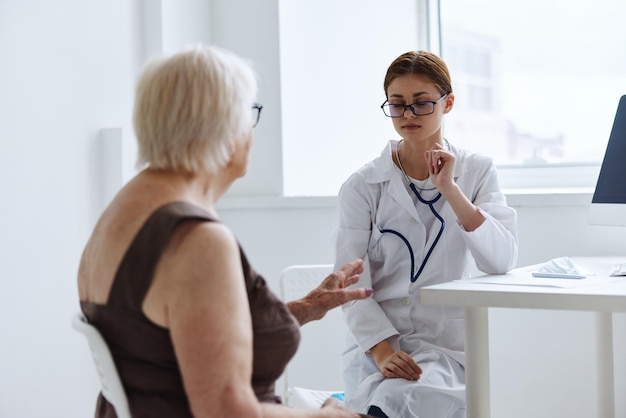 Elderly woman with glasses examination by a doctor health diagnostics