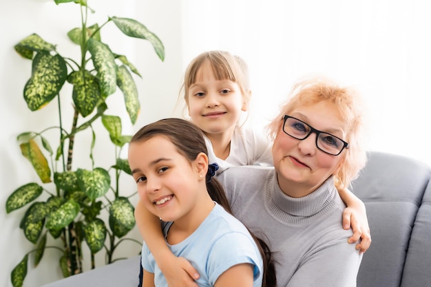 Elderly woman with her little granddaughters.