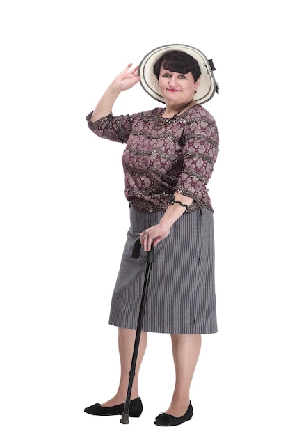 Elderly woman with a walking stick in a summer hat