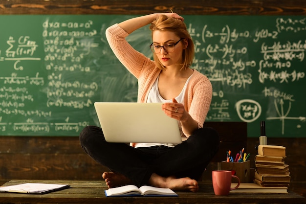 Elearning Online Study Learning Concept Portrait of female teacher using modern technology laptop in her class People learning education and school concept