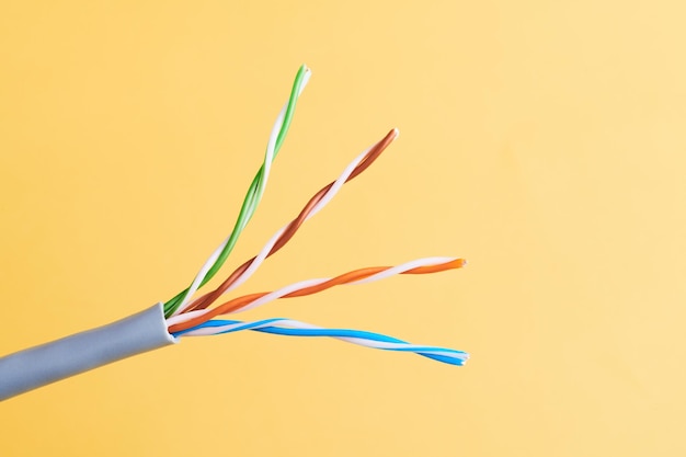 Electric cables many copper wires with colored isolation isolated on yellow background