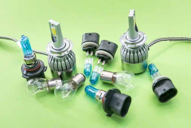 Electric car bulbs for headlight isolated on color background. Modern glass automotive lamp. Equipment for repair auto