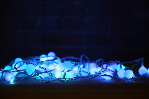 Electric Christmas garland on dark surface