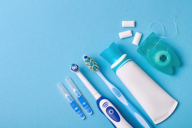 Photo electric and classic toothbrush on a blue background