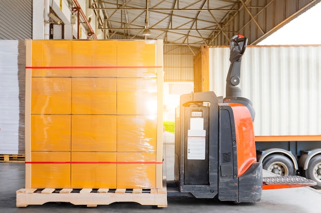 Electric forklift pallet jack with goods pallet shipment load into the truck