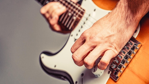 Electric guitar Man playing guitar Closeup hand playing guitar Musician playing guitar