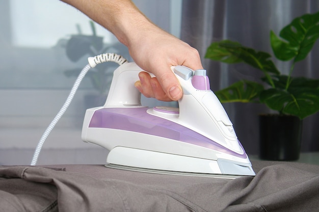 Electric iron on an ironing board