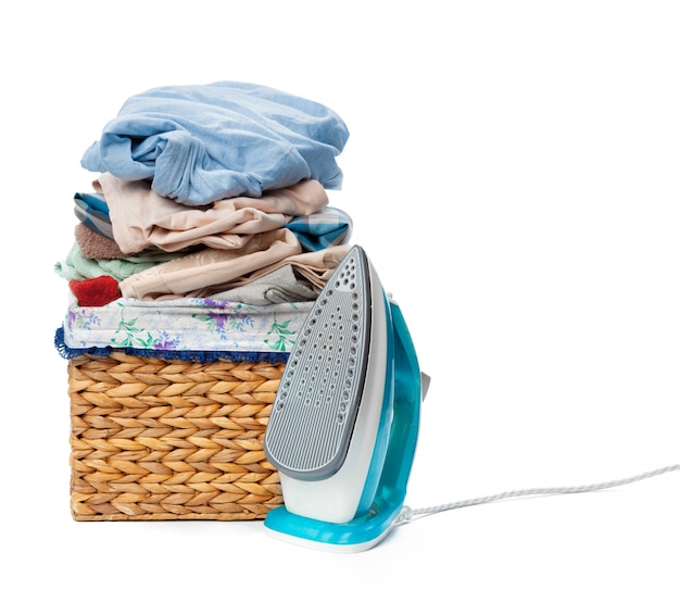 Electric iron and pile of clothes.