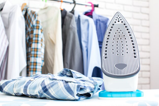 Electric iron and shirt, on cloth surface