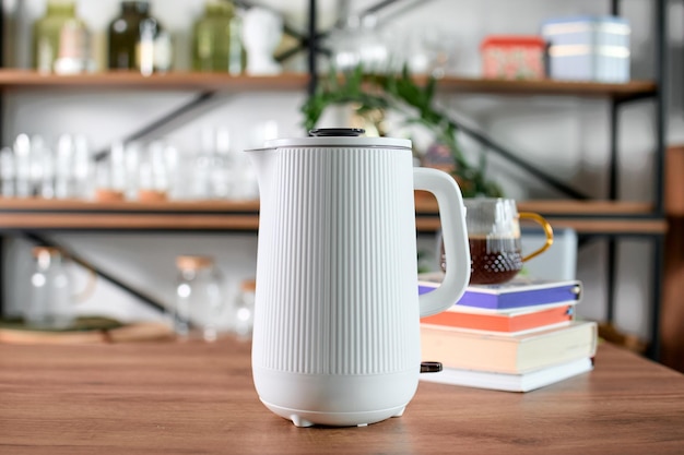 Photo an electric kettle stands on the kitchen table