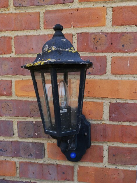 Photo electric lamp against brick wall