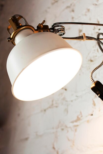 Electric lamp on a white brick wall